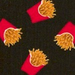 Tossed Small-Scale French Fries on Black